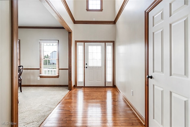 entrance foyer with light hardwood / wood-style flooring and ornamental molding