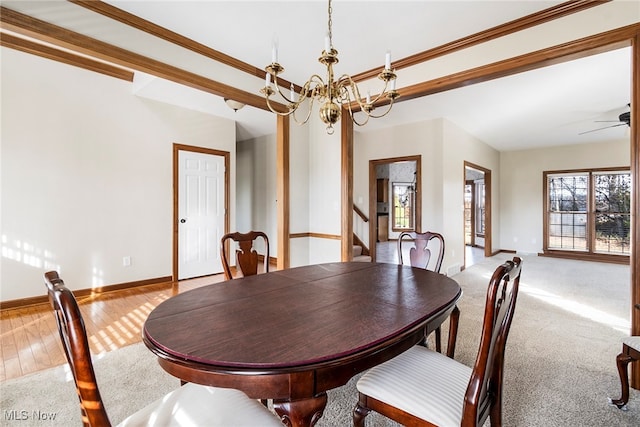 dining space with ceiling fan with notable chandelier, light hardwood / wood-style flooring, and crown molding