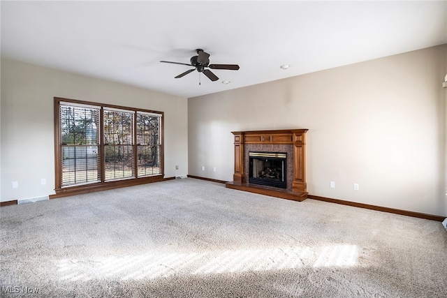 unfurnished living room featuring carpet floors and ceiling fan