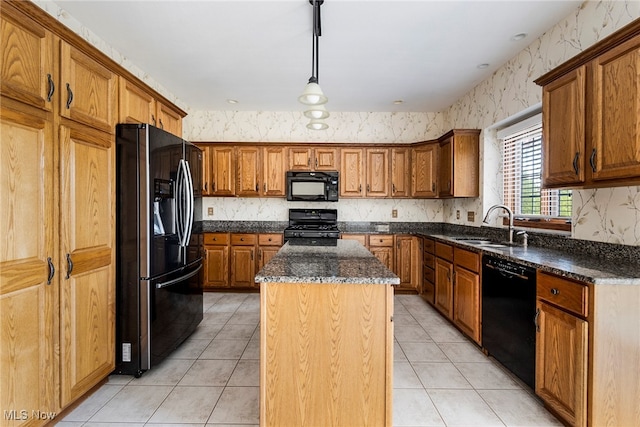 kitchen with a center island, sink, hanging light fixtures, light tile patterned floors, and black appliances