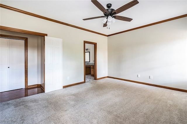 unfurnished bedroom featuring ensuite bath, ceiling fan, crown molding, a closet, and carpet