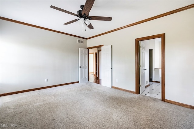 carpeted empty room with ceiling fan and crown molding