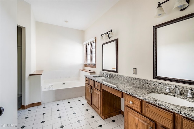 bathroom with vanity and a tub