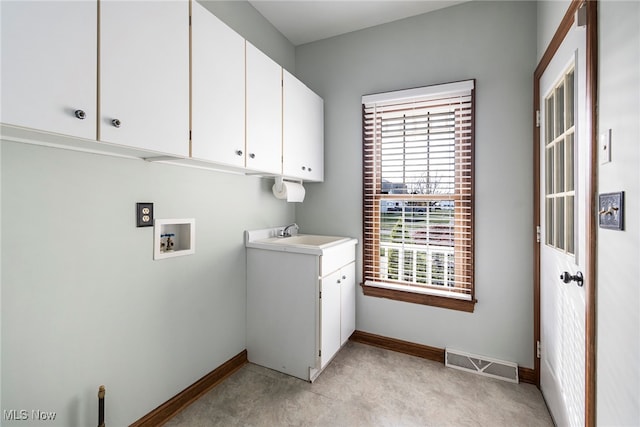 clothes washing area with cabinets, hookup for a washing machine, light carpet, and sink