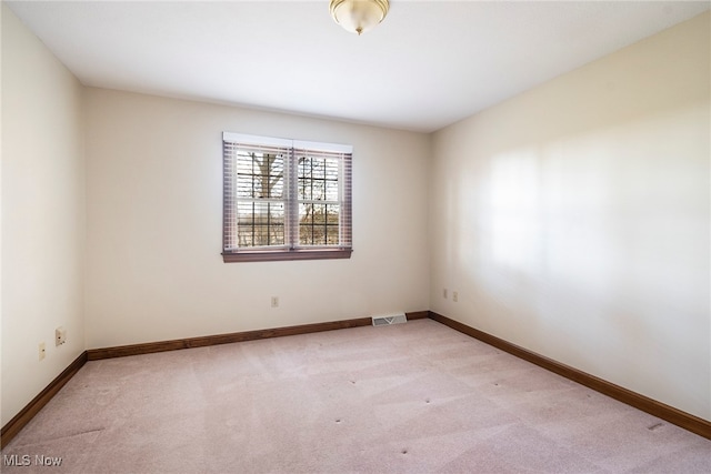 empty room featuring light carpet