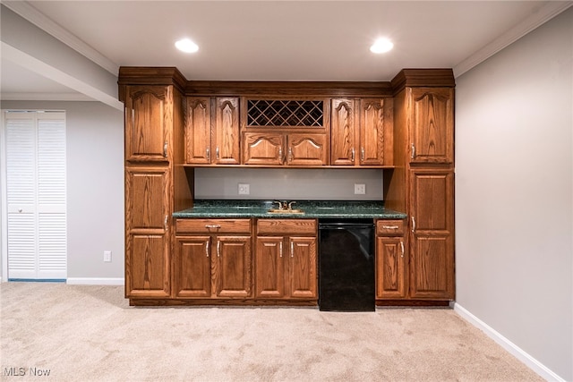 kitchen featuring sink, dark stone countertops, light colored carpet, and crown molding