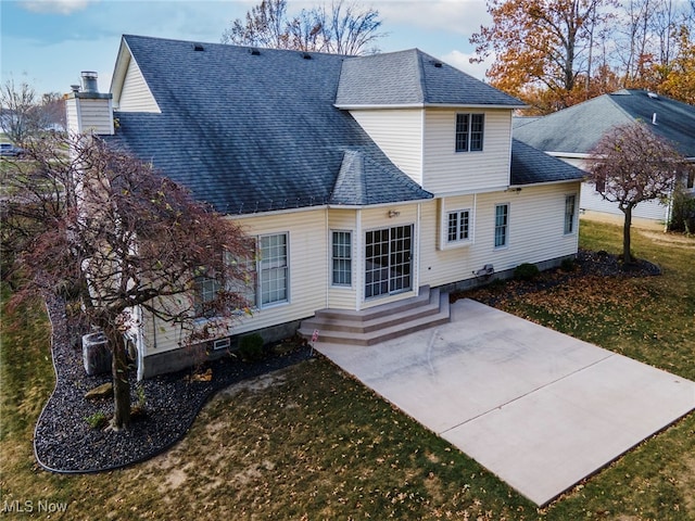 back of house featuring a yard and a patio