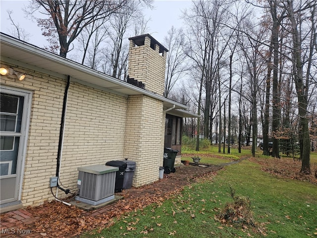 view of property exterior featuring a lawn and central air condition unit