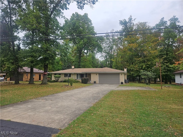 view of front of home featuring a garage and a front lawn