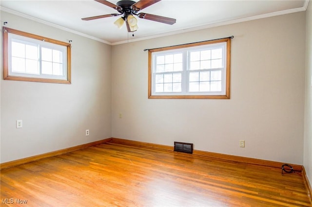 spare room featuring ceiling fan, hardwood / wood-style floors, and ornamental molding