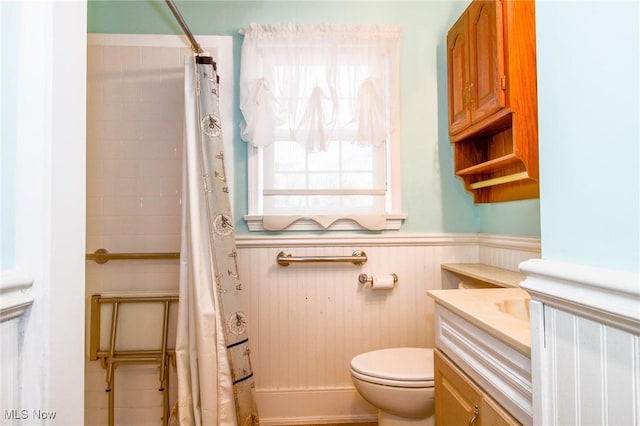 bathroom featuring walk in shower, vanity, and toilet