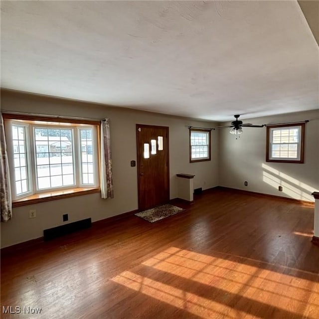 entrance foyer with hardwood / wood-style floors and a healthy amount of sunlight