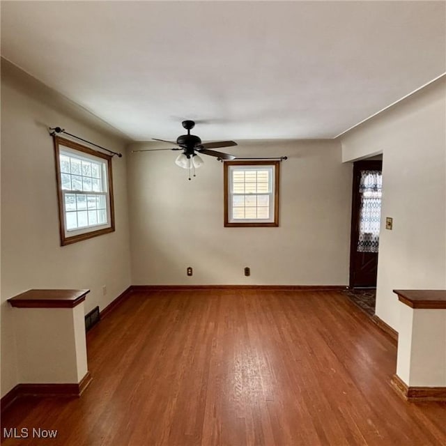 empty room featuring ceiling fan and wood-type flooring