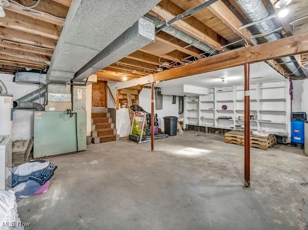 basement featuring water heater and heating unit