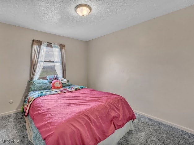 bedroom with carpet flooring and a textured ceiling