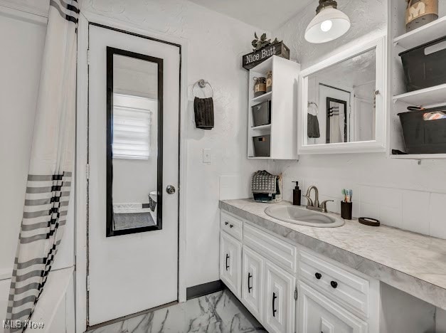 bathroom featuring shower / bath combo and vanity