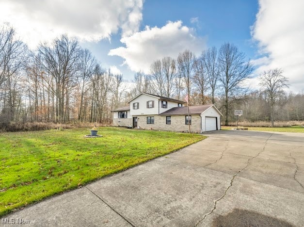 view of front of house with a garage and a front lawn