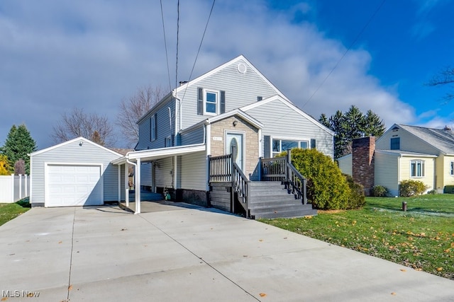 view of front of house with an outbuilding, a garage, and a front lawn