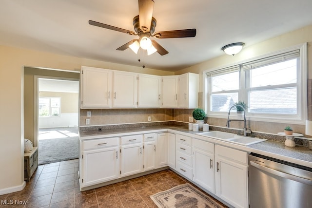 kitchen featuring sink, dishwasher, ceiling fan, white cabinetry, and decorative backsplash