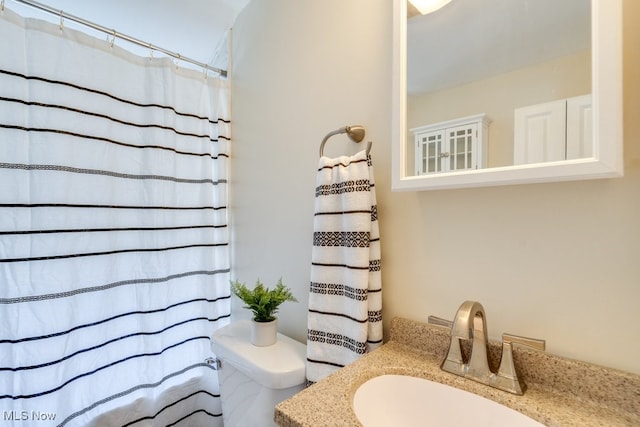 bathroom featuring vanity and toilet