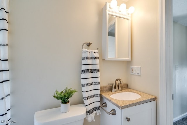 bathroom featuring vanity and toilet