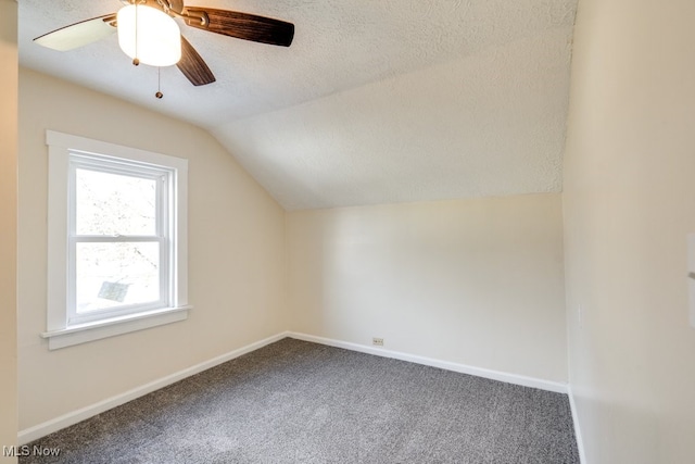 bonus room with vaulted ceiling, ceiling fan, carpet, and a textured ceiling