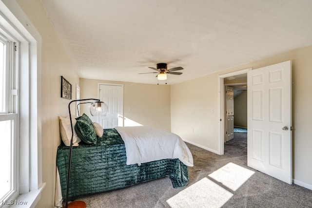 bedroom featuring multiple windows, carpet flooring, and ceiling fan