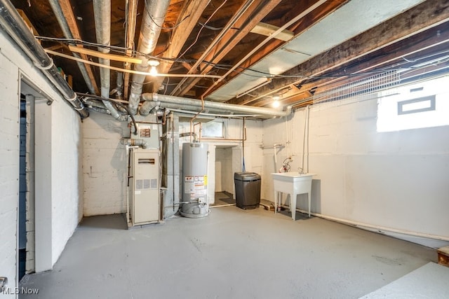 basement featuring heating unit, sink, and gas water heater