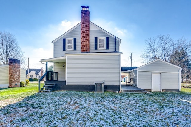 back of property featuring a storage shed, central AC unit, and a lawn