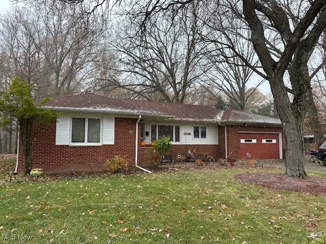 single story home with a garage and a front yard