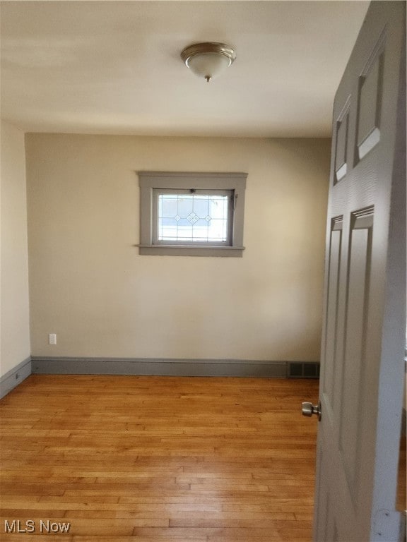 spare room featuring light wood-type flooring