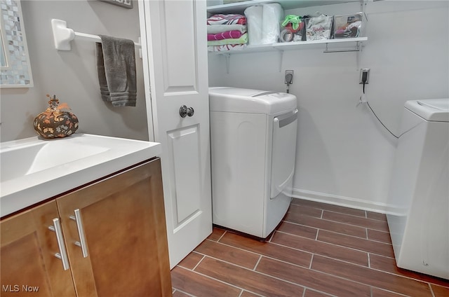 laundry room with washing machine and dryer and sink