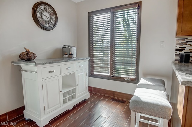 interior space featuring decorative backsplash and hardwood / wood-style flooring