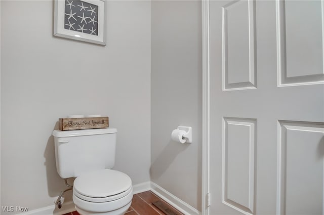 bathroom featuring hardwood / wood-style floors and toilet