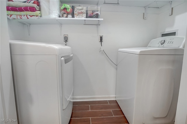 laundry room with separate washer and dryer and dark wood-type flooring