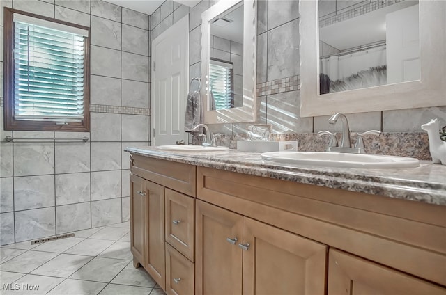 bathroom featuring tile patterned floors, vanity, a shower with curtain, and tile walls