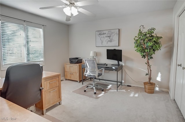 office area featuring light carpet and ceiling fan