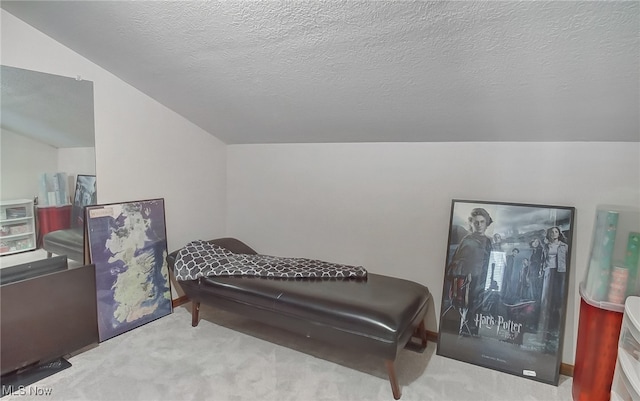 living area with carpet flooring, a textured ceiling, and vaulted ceiling