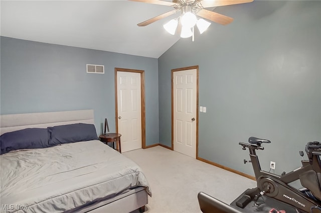 carpeted bedroom with ceiling fan and vaulted ceiling