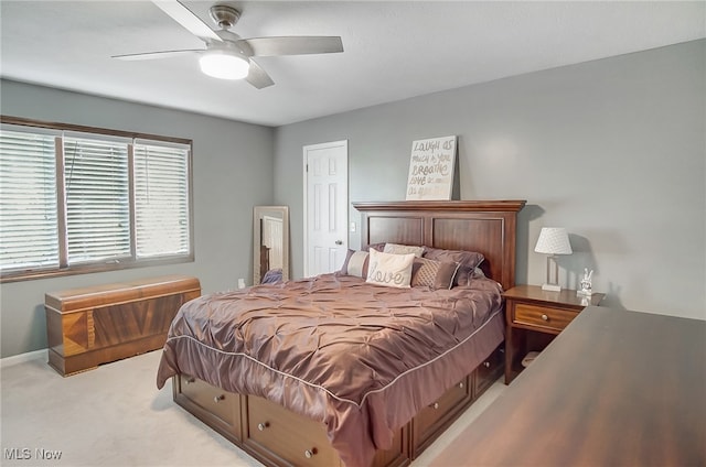 bedroom with ceiling fan and light carpet