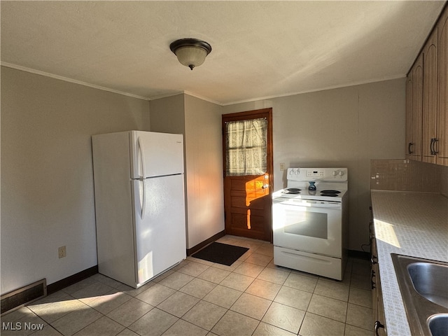 kitchen with crown molding, sink, light tile patterned floors, and white appliances