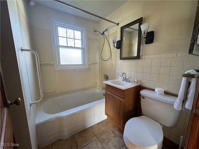 full bathroom with tile patterned floors, vanity, bathing tub / shower combination, tile walls, and toilet