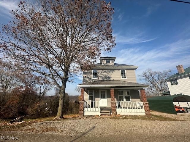 view of front of property featuring covered porch and a carport