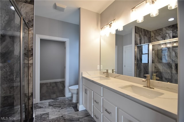 bathroom with vanity, toilet, and walk in shower