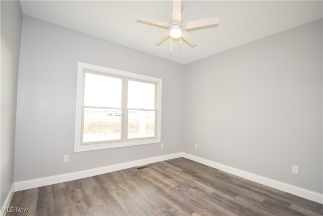 unfurnished room featuring dark hardwood / wood-style floors and ceiling fan