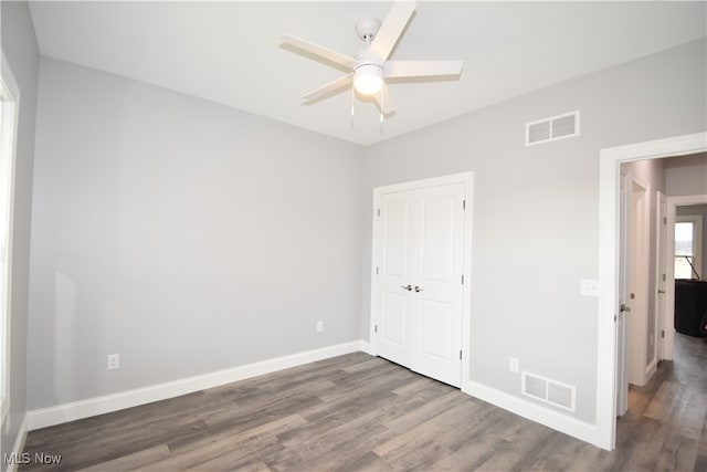 unfurnished bedroom with dark hardwood / wood-style floors and ceiling fan