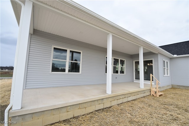 back of house featuring a porch