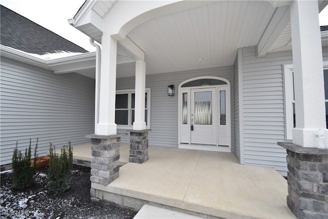 view of exterior entry with covered porch