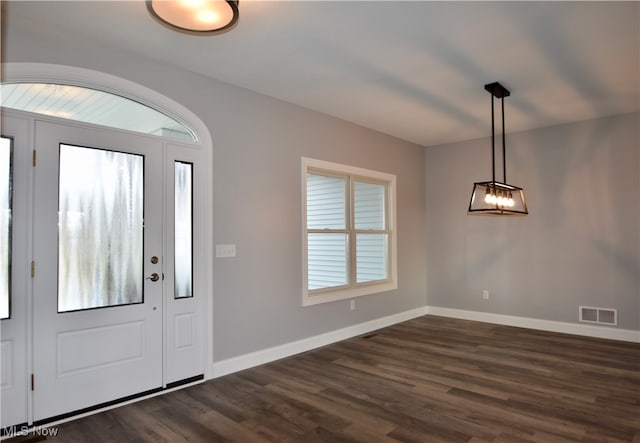 foyer entrance featuring dark hardwood / wood-style floors and a healthy amount of sunlight