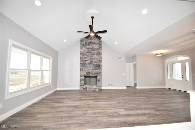 unfurnished living room with wood-type flooring, high vaulted ceiling, a stone fireplace, and ceiling fan